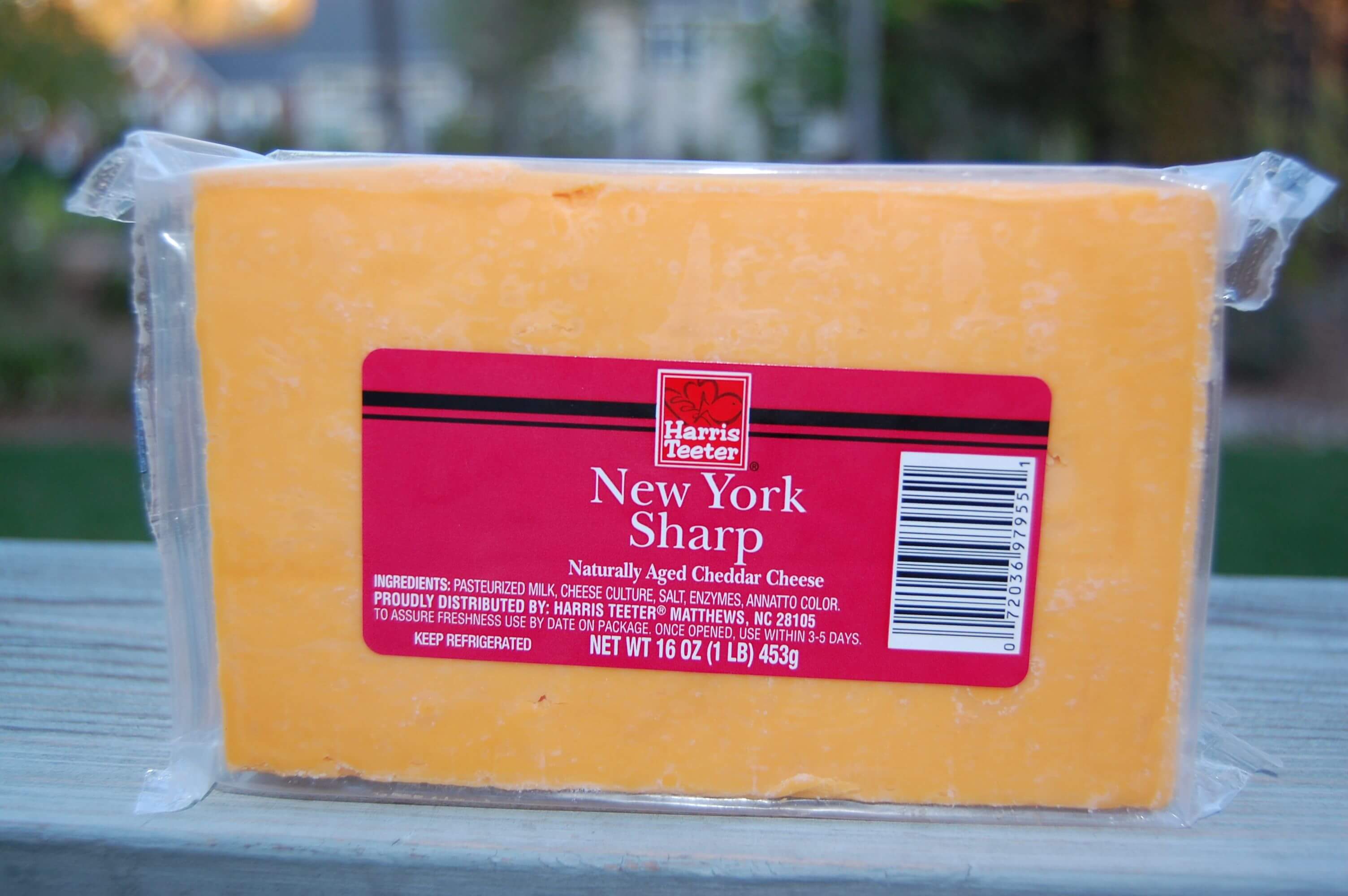 A block of packaged cheddar cheese from Harris Teeter.
