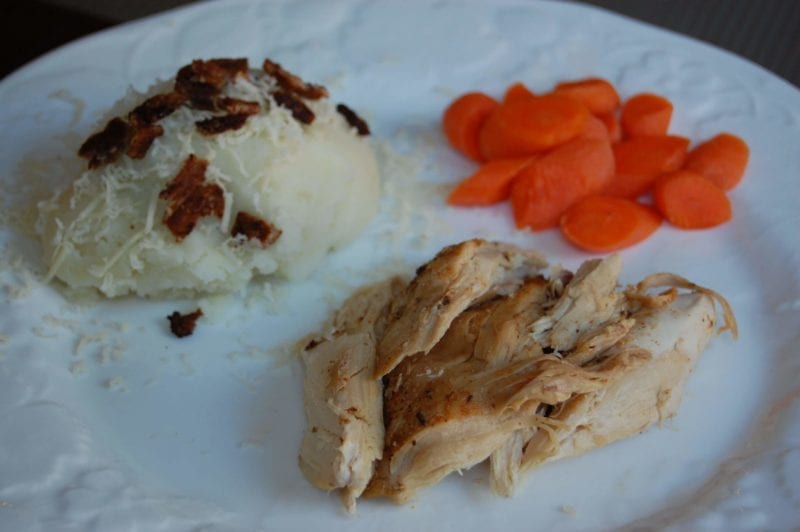 Crockpot chicken, mashed potatoes, and maple glazed carrots on a plate.