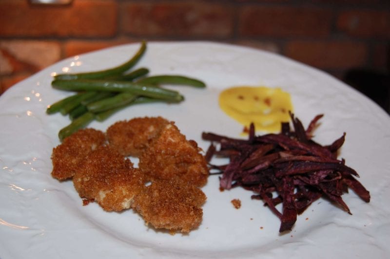 Homemade chicken nuggets, baked purple sweet potato fries with homemade honey mustard.