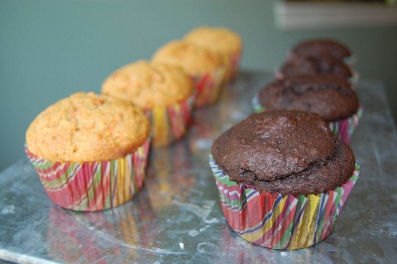 Two rows of chocolate and carrot cupcakes with no frosting.