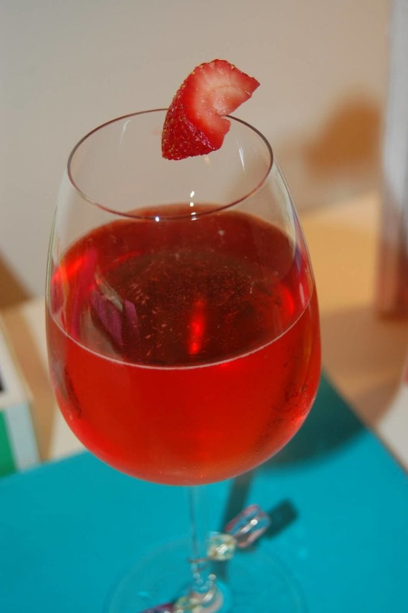 Sparkling wine and strawberry wine in a glass.