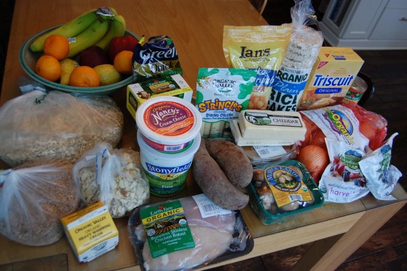 Groceries from Earth Fare that include produce, chicken, oats, cheese, crackers, and more.