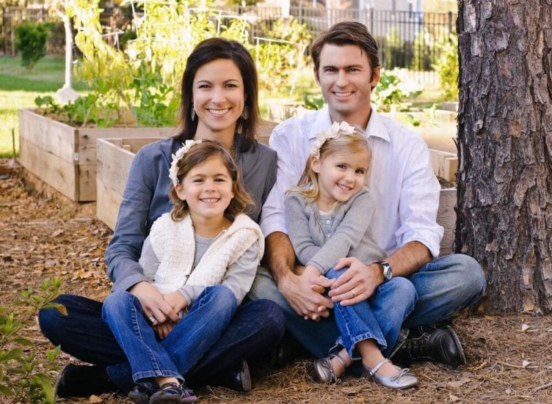 The Leake family of four posing together.