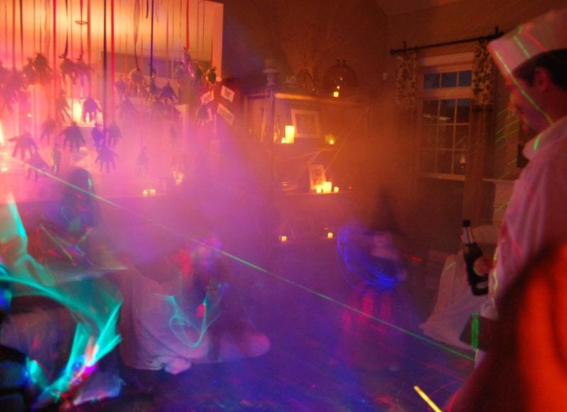 Inside of a house decorated for Halloween with kids dressed in costumes.