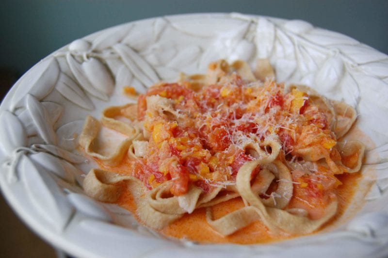 Homemade spaghetti with tomato sauce in a bowl.