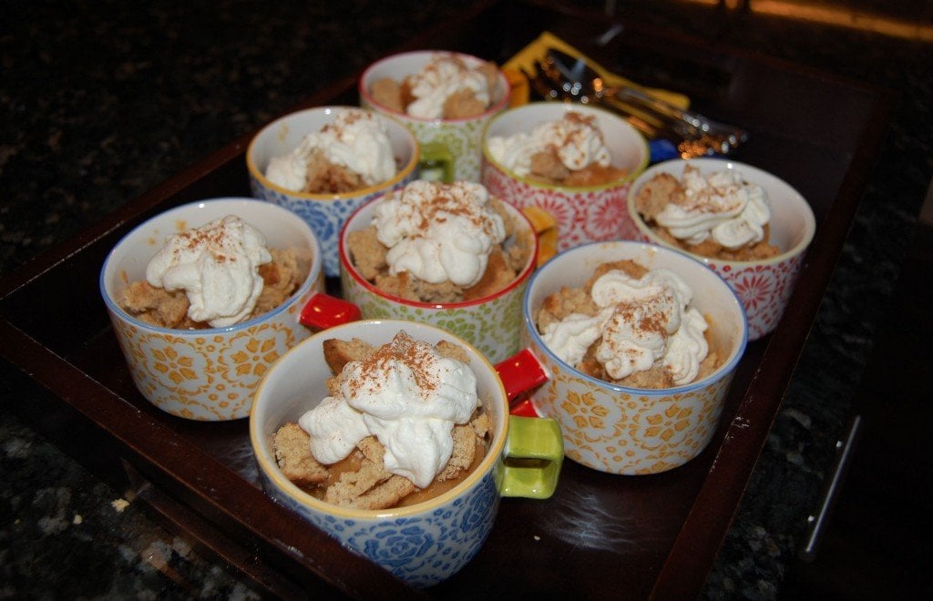 Homemade South Carolina peach sorbet topped with honey vanilla cookie crumble and whipped cream in mugs.