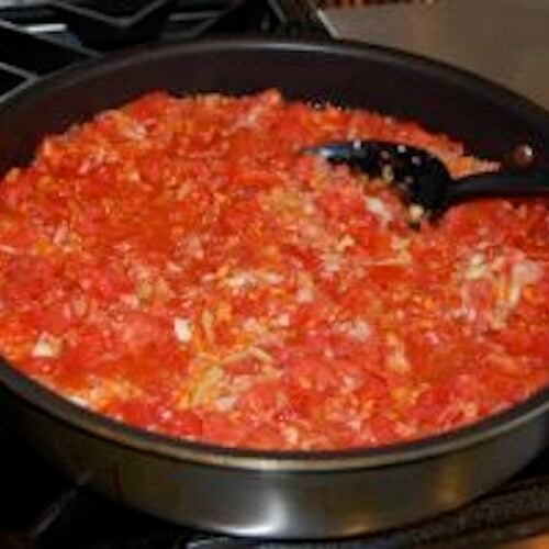 Homemade spaghetti sauce in a pot on the stove.