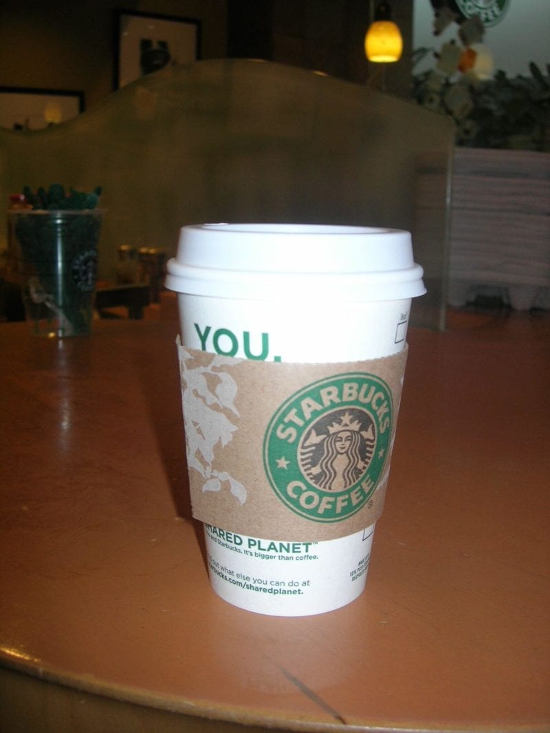 Starbucks coffee cup on a table.