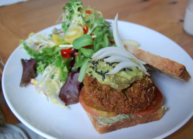 Veggie burger on whole-grain bread with a side salad from Luna's Living Kitchen in Charlotte, NC.