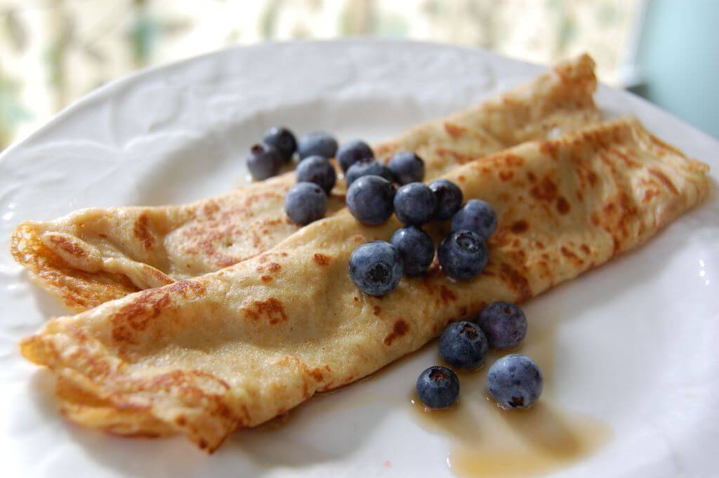 whole wheat crepes for breakfast with blueberries on plate